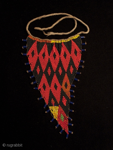 A small cache-sex, or pikuran, from the Kirdi people of Cameroon. This triangular 'tanga' style was probably worn by younger women for protection against the evil eye and also to attract attention.  ...