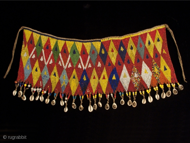 Pikuran (cache-sex), from the Kirdi people of the Cameroon.
Seed beads, cotton string, cowrie shells.
20" (51 cm) wide by 9" (23 cm) high.
Mid 20th century.         