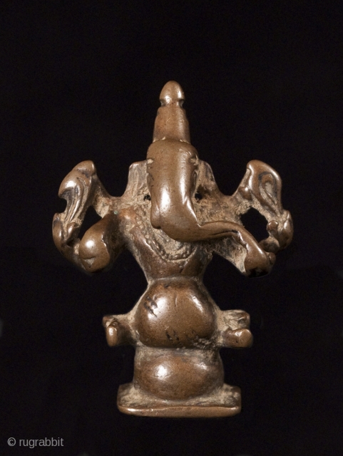 Ganesha, remover of obstacles, god of wisdom and prudence, India.
Lost wax cast bronze.
1 3/4 " (4.4 cm) high.
16th century.
#3522              