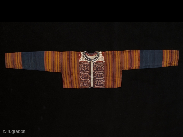 Young woman's ceremonial jacket, Kauer people, Western Highlands, South Sumatra. 55" (139.7 cm) wide by 11.5" (29.3 cm) high. Cotton, nassa shells, mica chips with supplementary weft back panel. Early 20th century.  ...