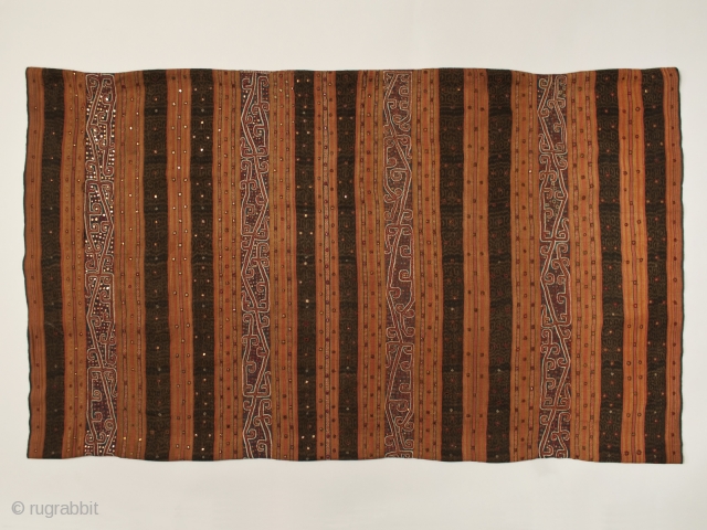 Tapis ceremonial garment
Kauer people, Lampung, Southwest Sumatra
Warp ikat, silk embroidery, mica chips
43" (109 cm) wide by 25.5" (64.7 cm) as folded, 51" if opened at seam
19th century      