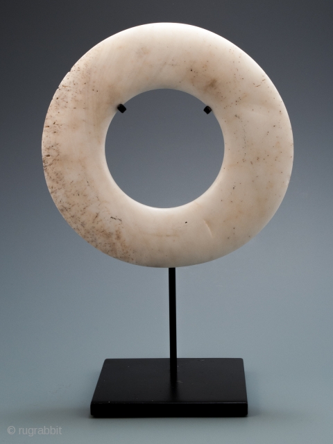 Yua currency shell ring,
Maprik area, East Sepik Province, Papua New Guinea.
Tridacna shell.
6.5" (16.5 cm) diameter.
Late 19th to early 20th century.

From the giant tridacna clam shell, currency rings were laboriously crafted with grit,  ...
