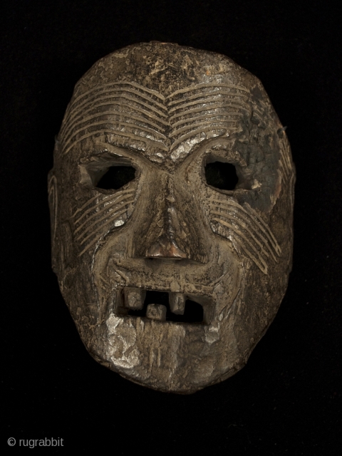 Mask, Middle Hills, Nepal. 7" (18 cm) high by 5.5" (14 cm) wide. 18th century or earlier. A powerful piece with a little charred area near the right eye.    