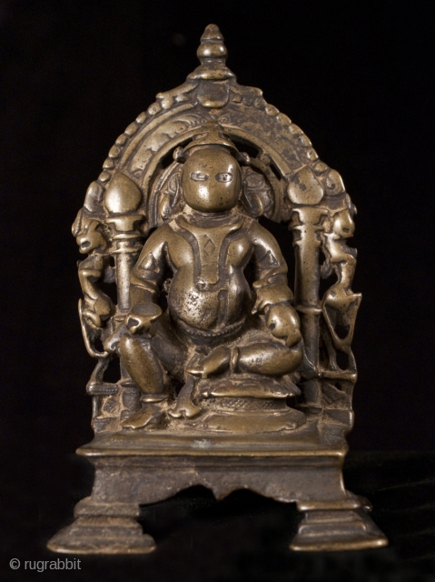 Kubera, India.
Lost wax cast bronze.
5 1/2" (14 cm) high.
13-16th century.

This is a small portable bronze shrine of Kubera, the god of riches and guardian of the north. He is short and portly  ...