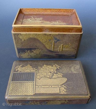 Japanese Antique Gilt Lacquer Kobako with Inside Tray
Antique Japanese small kobako (incense box) with inside tray. The outside is decorated with a scene of a garden fence, chrysanthemums, hydrangeas and daisies in  ...