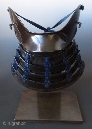 Japanese Hanpo Cheek Guard Armor
Japanese samurai hanpo cheek guard armor. Black lacquered iron with 4 lamellar neck guard, laced with dark blue silk cords. The cheek guard is lacquered in red. Mounted  ...