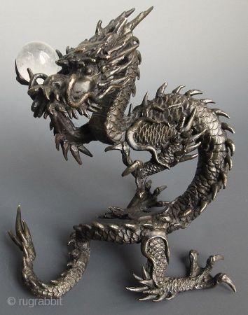 Japanese Bronze Dragon with Crystal Ball
Japanese bronze sculpture of a coiling dragon, holding a clear quartz crystal ball in its raised claw. The foot is cast with the two character seal of  ...