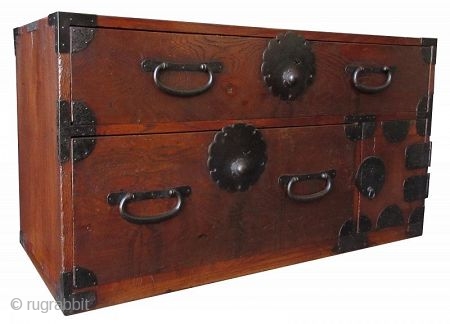 AntiqueJapanese Single Section Burl Keyaki Tansu
Japanese single section clothing tansu, with Kuri burl hardwood front drawers, iron lock plates with foliate edges, warabite pulls, fan-shaped iron corner hardware. The bottom corner has  ...