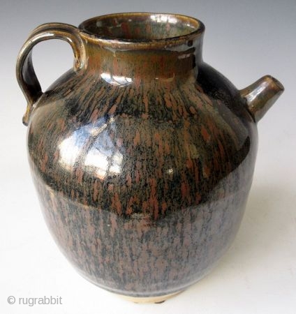 Antique Japanese Tenmoku Ware Handled Vessel


Japanese tenmoku ware ceramic vessel with ribbed handle, short front spout, and wide open top. The thick oil slick glaze stops just short above the foot left  ...