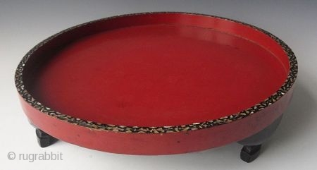 Edo period Japanese Circular Red and Black Lacquered Inlaid Stand

An unusual Japanese circular wooden stand with black and red lacquer finish, the edges of the stand are inlaid with shell, standing on  ...