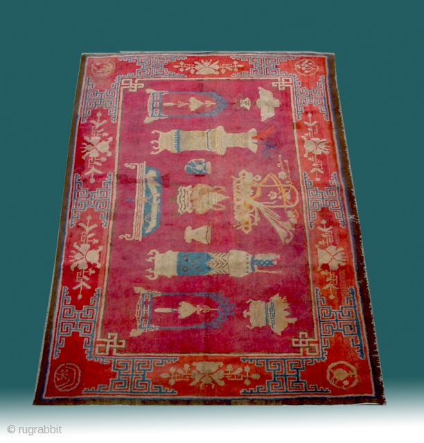 No.R022 * Chinese Antique "Vase Design" Rug,Age:19th Century.Size: 136x219cm(4'6"x7'2").Origin: Baotou-Suiyuan.Shape: Rectangle.Background Color: Reds.
This interesting carpet depicts the symbols of Hundred of Antiques: the incense burner, the teacup, the Ruyi (meaning wish come  ...