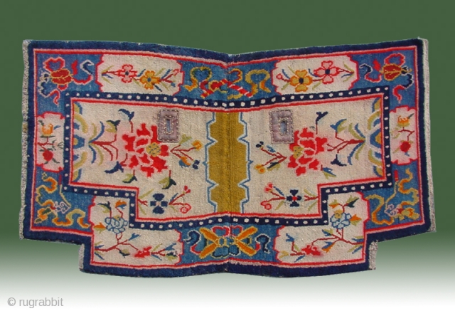 No.R130 * Antique Tibet Saddle Rug. Age:19th Century. Size: 64 x 113cm (2'1"x3'8"). Origin:Tibet. Background Color:Off-whites,lvory.Flower design on an intricate linking "Eight Buddhist Symbols" border.        