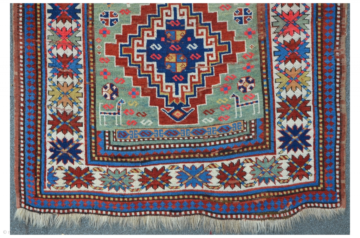 Kasak with green field 225 x 118 cm, some worn areas and ...