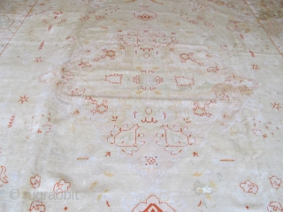 Very pale antique Borlu carpet with Angora wool, 4.54m x 3.50m. Some old repairs, but still very decorative.               