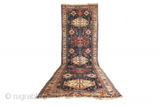 Antique Kuba long rug. Dated 1.904 (AH 1322),  375 x 135cm ( 101,5”x 66”).  
CAUCASIAN
 
This carpet features the appealing “Keyhole Design”. Two of the so-called ‘carnation’ borders, typical of  ...