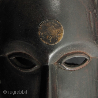 Nepalese Hill Tribe Mask:
Well carved tribal mask from Nepal. This is made from a heavy, densely grained wood with an old Nepalese rupee set in the forehead and an animal hide goatee  ...