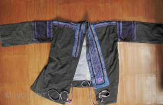 Dong Women’s Jacket: Women’s jacket from the Dong minority in Longsheng Terraces, Guangxi Zhuang, China. The black outer cloth is commercial denim, the lining is handmade indigo cotton with beautiful purple hand  ...