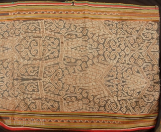 Good Iban woman’s kain depicting tree of life with bamboo running the length of the bidang reaching above the forest canopy, circa 1950s. Aside from commercial warp thread on sides, it is  ...