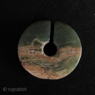 Good aventurine (usually mistaken for jade) slit earring disc “jue” from the Lopburi Bronze Age culture in Central Thailand circa 500 BCE-500 CE. Has one old chip and calcification- condition as pictured.  ...
