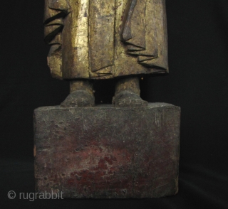 Very rare standing wood folk image of the Buddha statue from the Tai Lue ethnic group in the Golden Triangle region. This Buddha is classically robed in the Mandalay style with a  ...