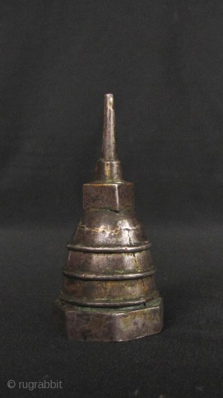 Silver plated copper reliquary box in the shape of a Sinhalese chedi (stupa) with hexagonal base, Kandy period Sri Lanka. This would have kept a tiny amount of ash or bone from  ...