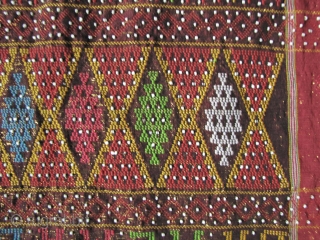 



Indonesia, Batak Ulos: Colorful hand woven beaded shoulder cloth from the Batak people, Sumatra. This piece is quiet lively and complicated with gold treads, and large “Rasta” colored diamond patterned warp embroidered  ...