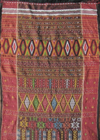 



Indonesia, Batak Ulos: Colorful hand woven beaded shoulder cloth from the Batak people, Sumatra. This piece is quiet lively and complicated with gold treads, and large “Rasta” colored diamond patterned warp embroidered  ...