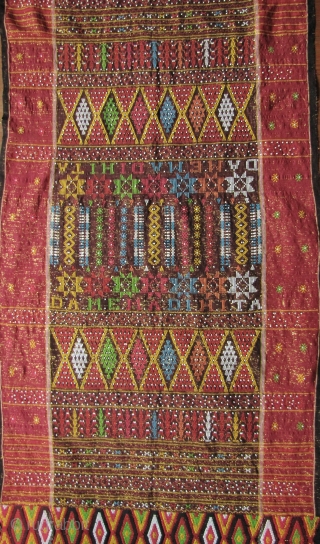 



Indonesia, Batak Ulos: Colorful hand woven beaded shoulder cloth from the Batak people, Sumatra. This piece is quiet lively and complicated with gold treads, and large “Rasta” colored diamond patterned warp embroidered  ...