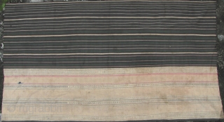 Semi antique woman’s sarong from the Stieng/Xtiêng ethic group Vietnam. Over 60 years old, this is woven from all handspun cotton threads. There is one ink stain and a small hole (see  ...