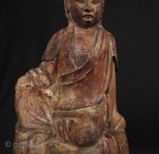 Qing Dynasty Guanyin: Lovely, circa 18th century wood statue of the Chinese Goddess of Mercy seated on a lotus leaf and buds.  There is one stem broken on the left bud  ...