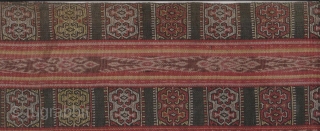 Semi antique Timor sarong made from all natural dyes and handspun cotton circa 1950/1960. Both top and bottom have “buna” weft embroidered panels. There is a 7cm x 4cm piece missing on  ...