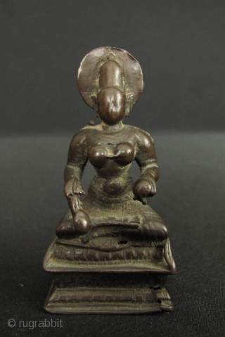 Small bronze image of Annapurna; the Goddess of the hearth and food (as well as a whacking big mountain named after her). She sits holding a ladle with which she feeds the  ...