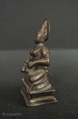 Small bronze image of Annapurna; the Goddess of the hearth and food (as well as a whacking big mountain named after her). She sits holding a ladle with which she feeds the  ...