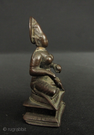 Small bronze image of Annapurna; the Goddess of the hearth and food (as well as a whacking big mountain named after her). She sits holding a ladle with which she feeds the  ...