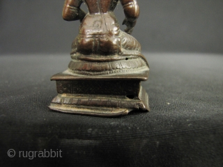 Small bronze image of Annapurna; the Goddess of the hearth and food (as well as a whacking big mountain named after her). She sits holding a ladle with which she feeds the  ...