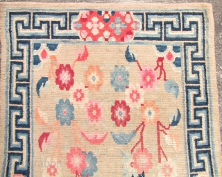 Special offer: Tibet Khaden Rug: Tibetan carpet with auspicious floral pattern and ”meander” border. l: 168cm/67in and w: 84cm/33in. There is some wear in the center and it is faded on one  ...