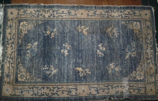 Old Chinese rug woven in Beijing/Tianjin, circa late 19th to early 20th century, with abstract archaic foliate border and ten floral sprays on the field repaired with frayed edges- still quite pretty  ...