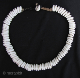 Antique Naga Beads:Antique: Fine and rare Naga child’s cowrie shell necklace from northwest Burma on hand woven macramé cotton cord. These is an old set, circa 80 years with an excellent worn  ...