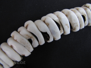 Antique Naga Beads:Antique: Fine and rare Naga child’s cowrie shell necklace from northwest Burma on hand woven macramé cotton cord. These is an old set, circa 80 years with an excellent worn  ...