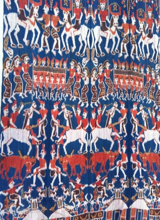Outstanding example of Sumba Hinggi Ikat. A festive ceremonial parade. Large group of people riding on horses and parading while other people carrying an ark field with ladies, on their shoulders. Other  ...
