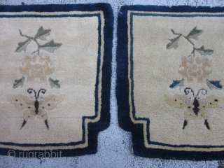 Two shaped Peking Chinese mats circa 1920's,each measuring 1.5 x 1.5.Charming mats with lush,unworn piles,with indented top corners.The creamy beige fields of each has a butterfly and paeony spray on an otherwise  ...