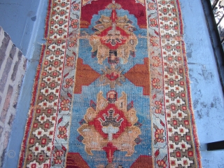 Possibly Northwest Persian or Eastern Turkish,Probably Kurdish,measuring 5.10 x 3.1,mid-19th century.Totally rustic and tribal,two huge palmettes set on a charming light blue field with rust and dark brown tones.The foundation is all  ...