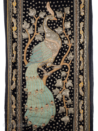 Antique Zardozi Peacock Wall Hanging

The heavily padded peacock stands proud of the black velvet ground and is rendered in gold and silver wrapped turquoise silk threads. Enclosed by multiple decorative borders and  ...