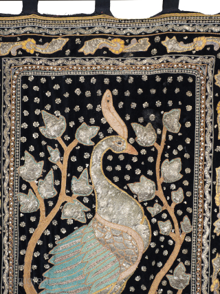 Antique Zardozi Peacock Wall Hanging

The heavily padded peacock stands proud of the black velvet ground and is rendered in gold and silver wrapped turquoise silk threads. Enclosed by multiple decorative borders and  ...