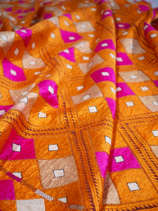 Orange and Pink Phulkari Bagh Early 20th Century

Punjab, early 20th Century circa 1920s/30's. 228cm x 132.5cm cm (89 x 52 inches). Densely embroidered with six and a half rows of large lozenges, latticed in the most  ...