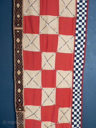 Rare, Royal, Red Check Kuba Cloth

The central panel comprises alternate squares of coarse plain raffia and finely woven red dyed raffia, the plain panels embellished with cowrie shells. Bordered to one edge  ...