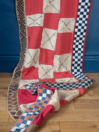 Rare, Royal, Red Check Kuba Cloth

The central panel comprises alternate squares of coarse plain raffia and finely woven red dyed raffia, the plain panels embellished with cowrie shells. Bordered to one edge  ...
