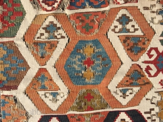 Early Anatolian hooked kilim, one wing. Clean, very good colors (purple, apricot, nice greens), good condition for it's age. Interesting use of dark hooks as partitioning elements, creating a rhythm throughout the  ...