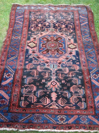 Antique Heriz 100% wool carpet, pre 1900.Beautiful natural colours:deep red,coral,indigo blue,cerulean blue against an inky midnight ground. Medallion centre. There are a few condition issues.Loss of fringe and a slight amount of  ...