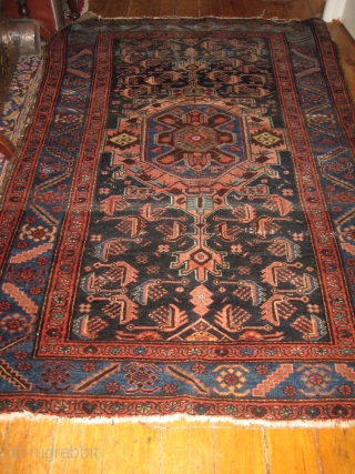 Antique Heriz 100% wool carpet, pre 1900.Beautiful natural colours:deep red,coral,indigo blue,cerulean blue against an inky midnight ground. Medallion centre. There are a few condition issues.Loss of fringe and a slight amount of  ...